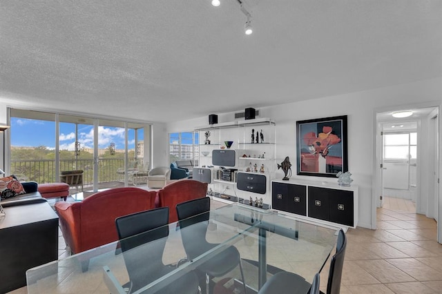 dining room featuring a textured ceiling and light tile patterned floors