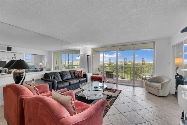 living room with a textured ceiling, light tile patterned flooring, and expansive windows