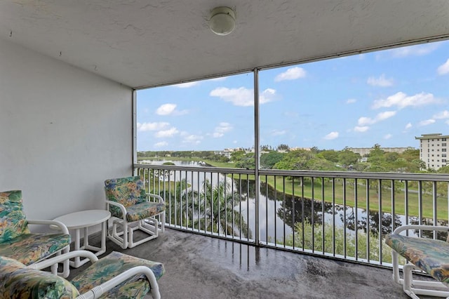 sunroom / solarium with a water view