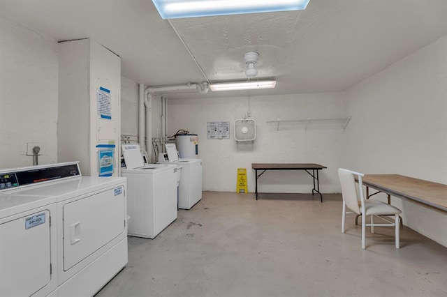 laundry area featuring water heater and washing machine and dryer