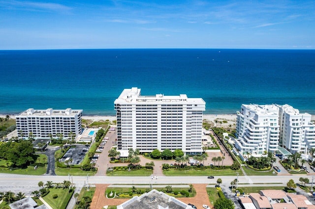 birds eye view of property with a water view and a beach view