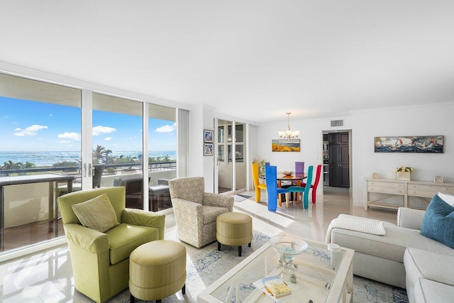 living room featuring a chandelier and a wall of windows