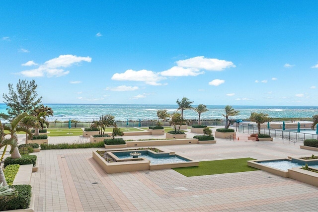 view of pool with a water view and a patio area