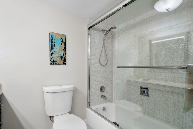 bathroom featuring shower / bath combination with glass door and toilet