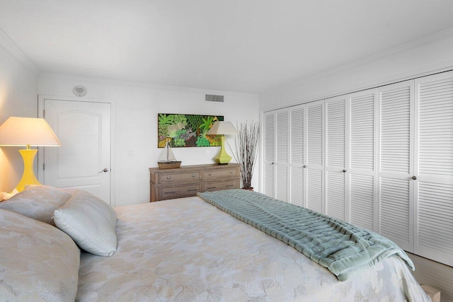 bedroom with ornamental molding and a closet