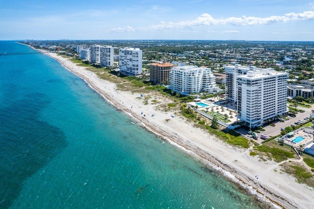 drone / aerial view featuring a beach view and a water view