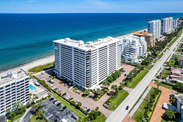 bird's eye view with a water view and a beach view