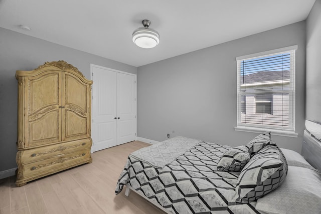 bedroom featuring light hardwood / wood-style floors and a closet