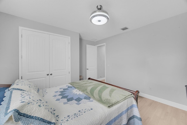 bedroom featuring light hardwood / wood-style floors and a closet