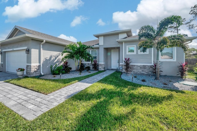 view of front of property with a garage, stone siding, a front yard, and stucco siding