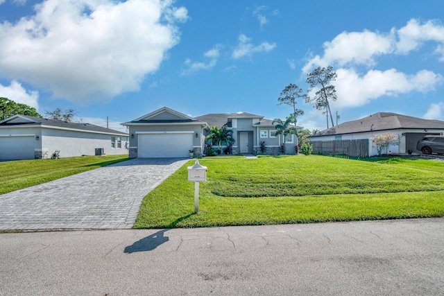 ranch-style home featuring a front lawn and a garage