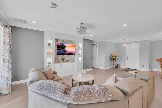 living room with light wood-type flooring and crown molding