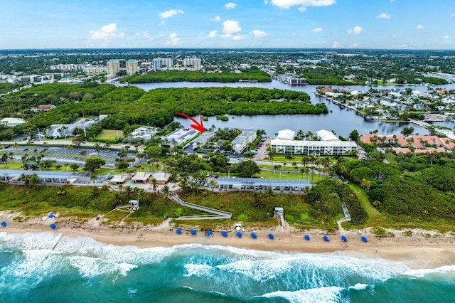 drone / aerial view featuring a water view and a view of the beach