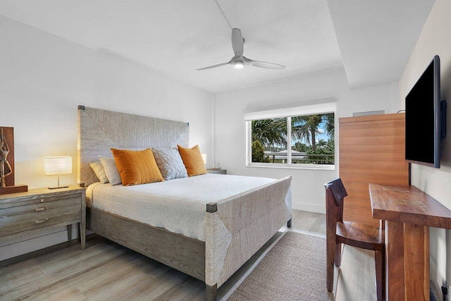 bedroom with ceiling fan and light wood-type flooring