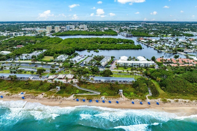 drone / aerial view with a beach view and a water view