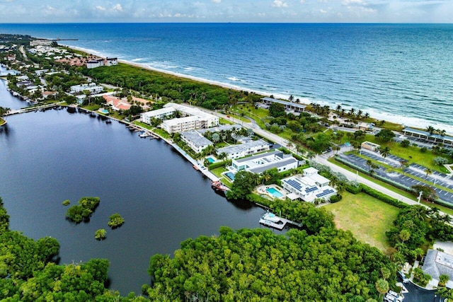 drone / aerial view with a beach view and a water view