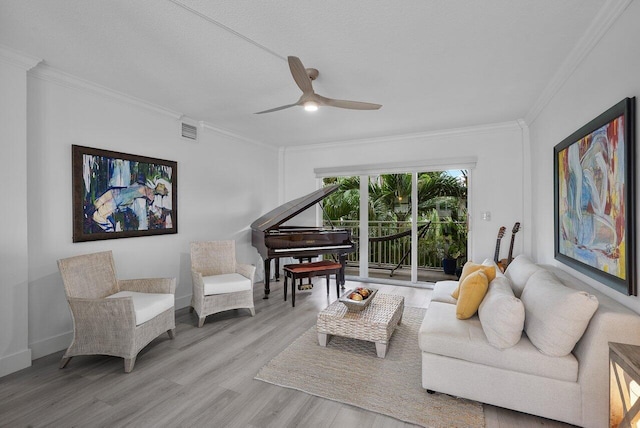 living room with hardwood / wood-style floors, ceiling fan, ornamental molding, and a textured ceiling