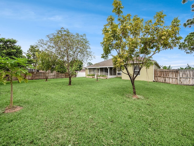 view of yard with a sunroom