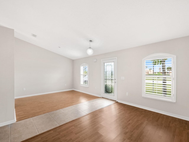 empty room featuring light hardwood / wood-style flooring and a wealth of natural light