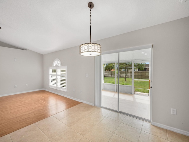 unfurnished room with light hardwood / wood-style flooring, a textured ceiling, and plenty of natural light