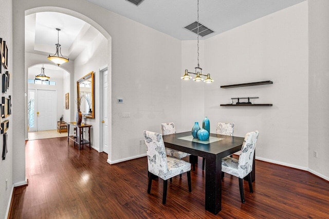 dining space with dark hardwood / wood-style flooring