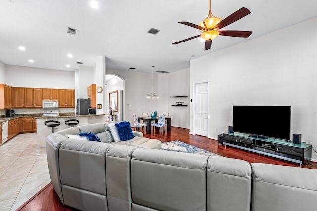 living room featuring ceiling fan and light tile patterned flooring