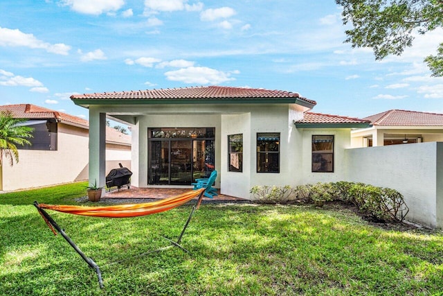 rear view of house featuring a lawn