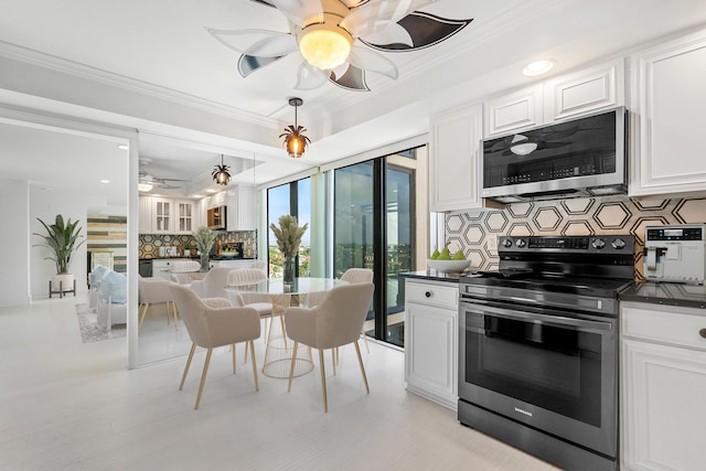 kitchen with backsplash, crown molding, white cabinetry, and stainless steel appliances