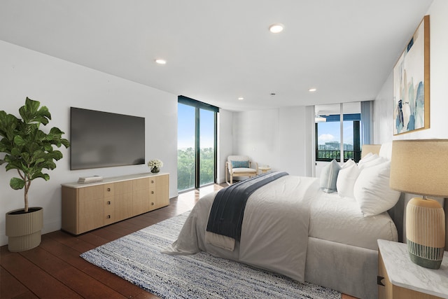 bedroom featuring dark hardwood / wood-style flooring, a wall of windows, and access to outside