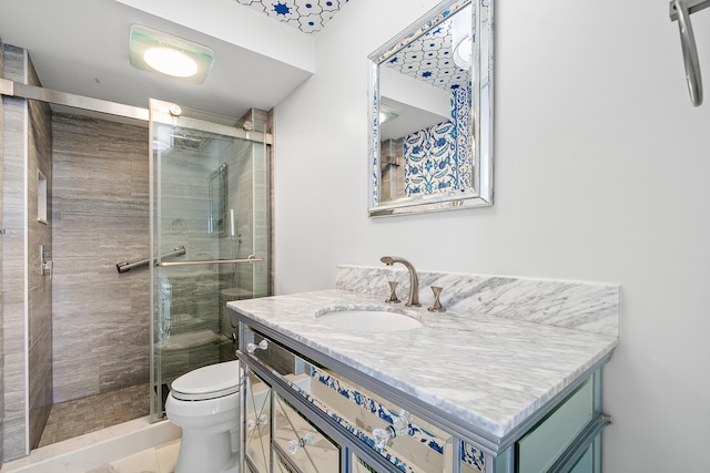 bathroom with walk in shower, tile patterned floors, vanity, and toilet