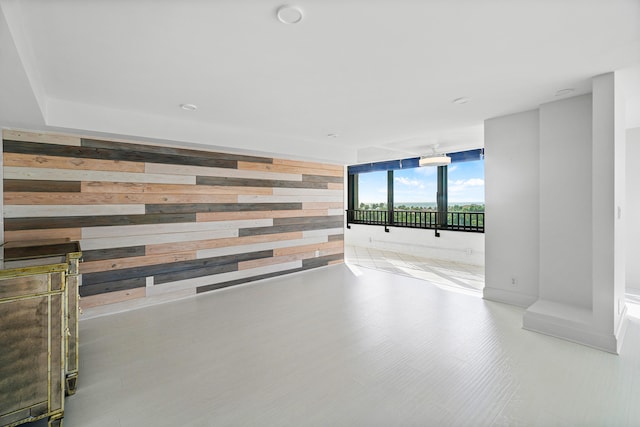 empty room featuring wood walls