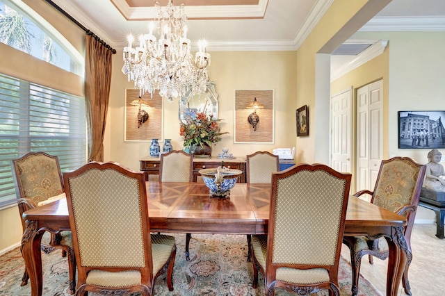 dining space with a chandelier, crown molding, baseboards, and a tray ceiling