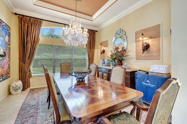 dining space featuring crown molding, a raised ceiling, light tile patterned flooring, and a chandelier