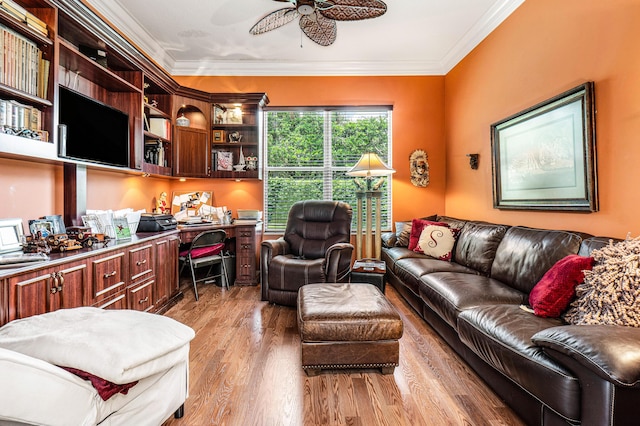 living room with ceiling fan, light wood-style floors, and crown molding