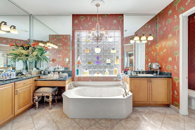 full bathroom featuring wallpapered walls, a chandelier, a tub with jets, vanity, and tile patterned flooring