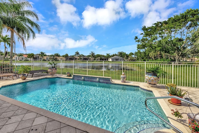 view of swimming pool featuring fence, a patio area, and a water view
