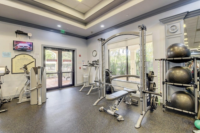 exercise room featuring french doors, ornamental molding, healthy amount of natural light, a raised ceiling, and recessed lighting