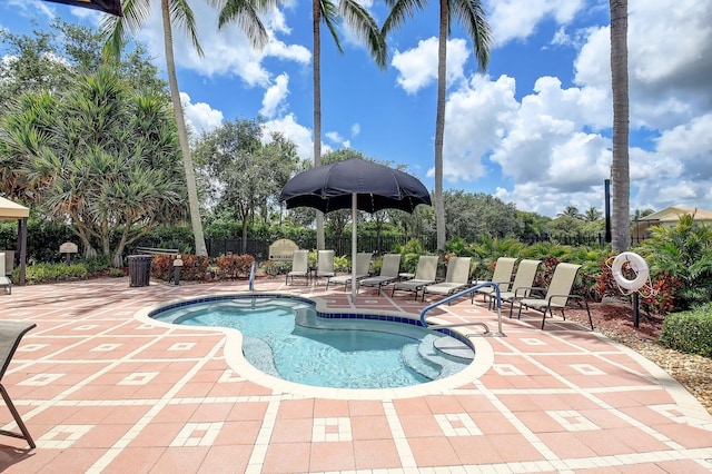 community pool with a patio and fence