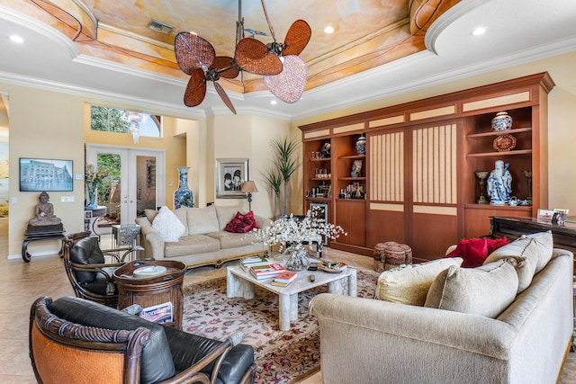 tiled living room featuring a raised ceiling, crown molding, french doors, a ceiling fan, and recessed lighting