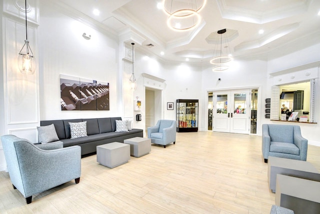 building lobby with a towering ceiling, coffered ceiling, ornamental molding, beamed ceiling, and recessed lighting