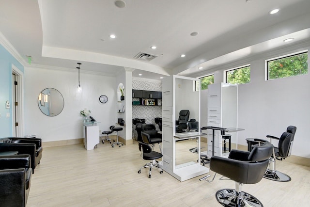 office area with light wood-type flooring, a tray ceiling, recessed lighting, baseboards, and ornamental molding