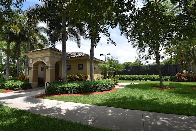 view of front of property featuring stucco siding and a tiled roof