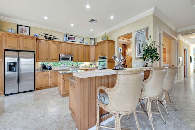 kitchen with stainless steel appliances, light tile patterned floors, decorative backsplash, a kitchen bar, and ornamental molding