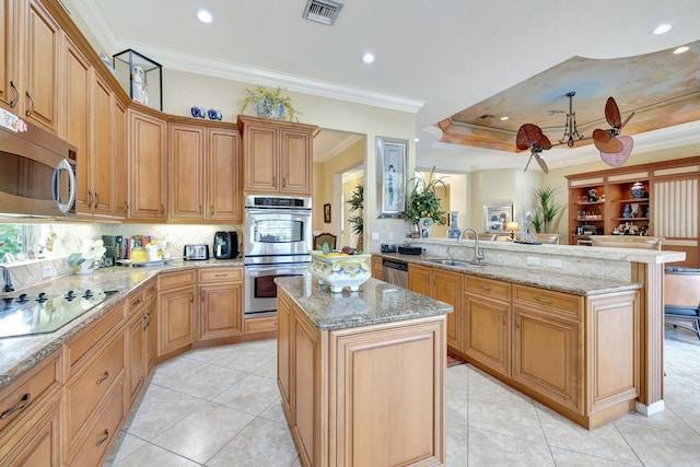 kitchen with kitchen peninsula, light tile patterned floors, appliances with stainless steel finishes, a kitchen island, and crown molding