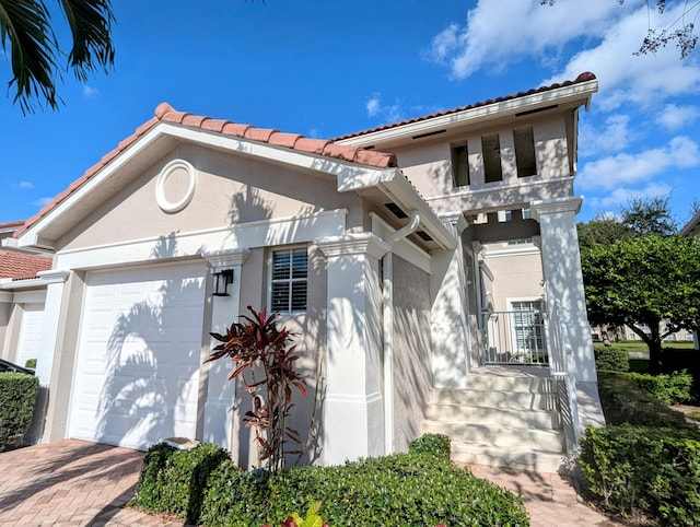 mediterranean / spanish house with a garage