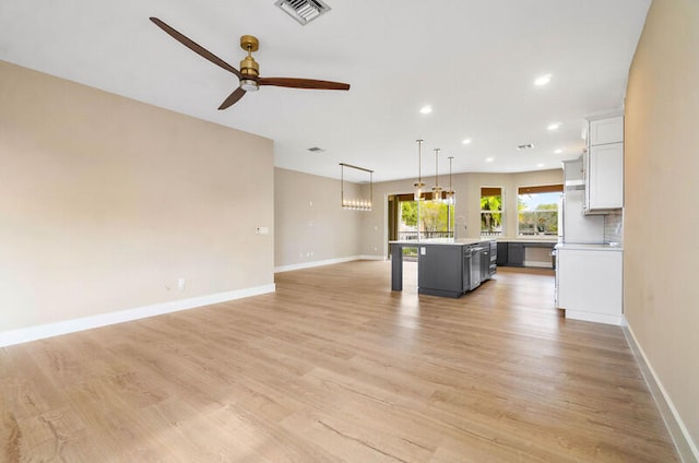 unfurnished living room featuring light hardwood / wood-style floors and ceiling fan