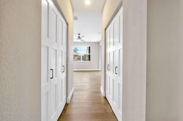 hallway with wood-type flooring