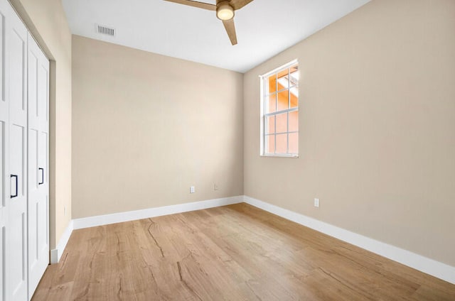 unfurnished bedroom featuring light hardwood / wood-style flooring, a closet, and ceiling fan