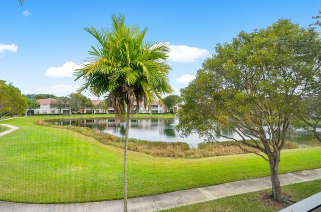 view of home's community featuring a water view and a lawn