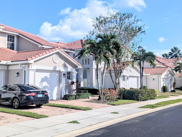 mediterranean / spanish house with a garage